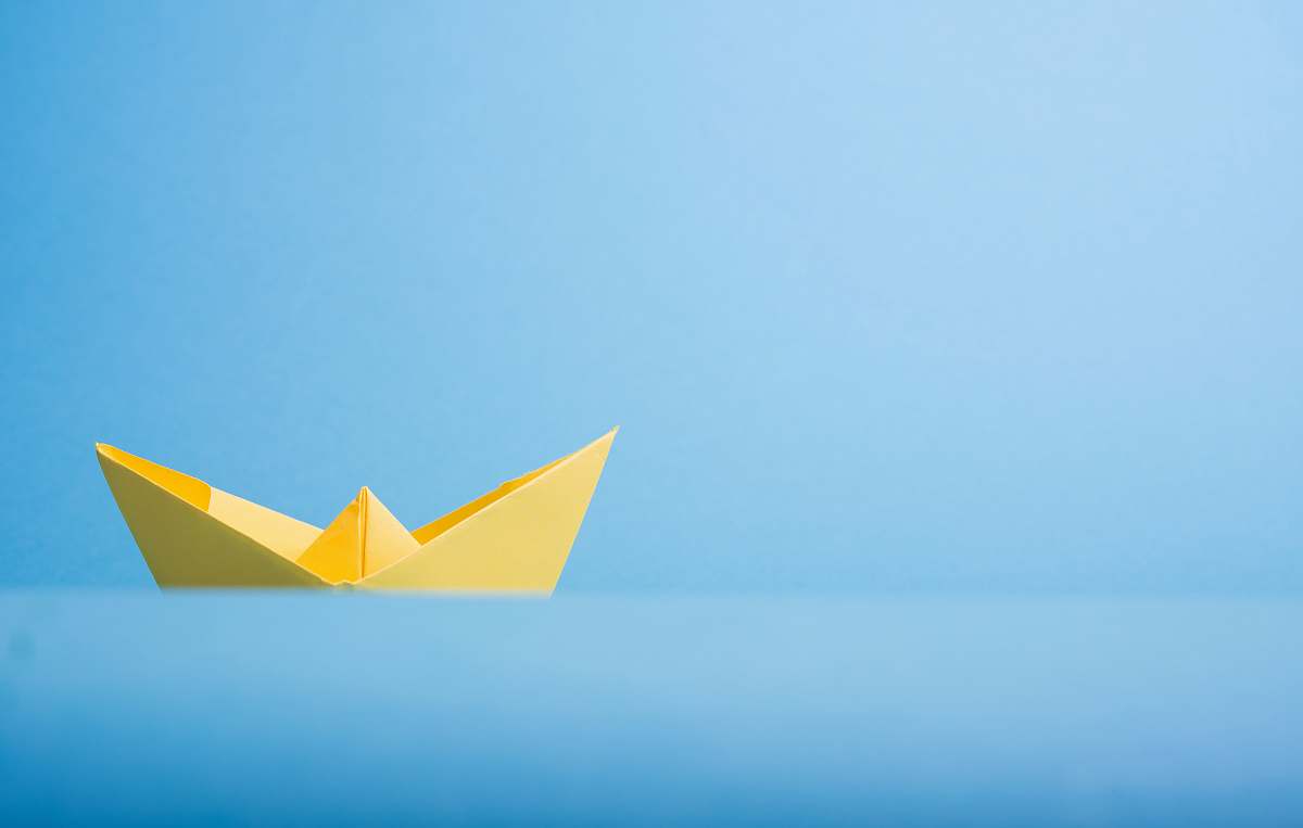 origami closeup photo of yellow paper boat art