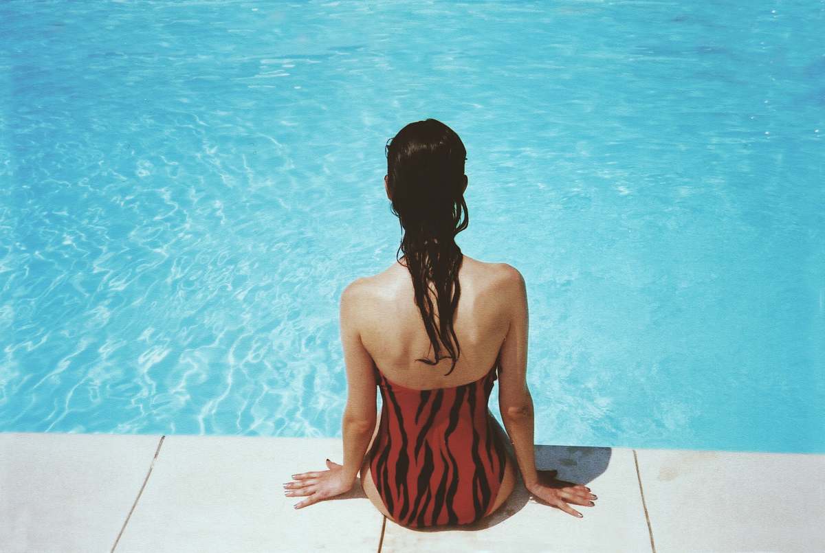 person woman wearing black and red monokini summer