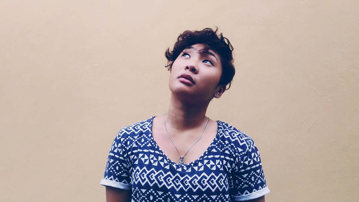 woman woman wearing black and white shirt looking above portrait