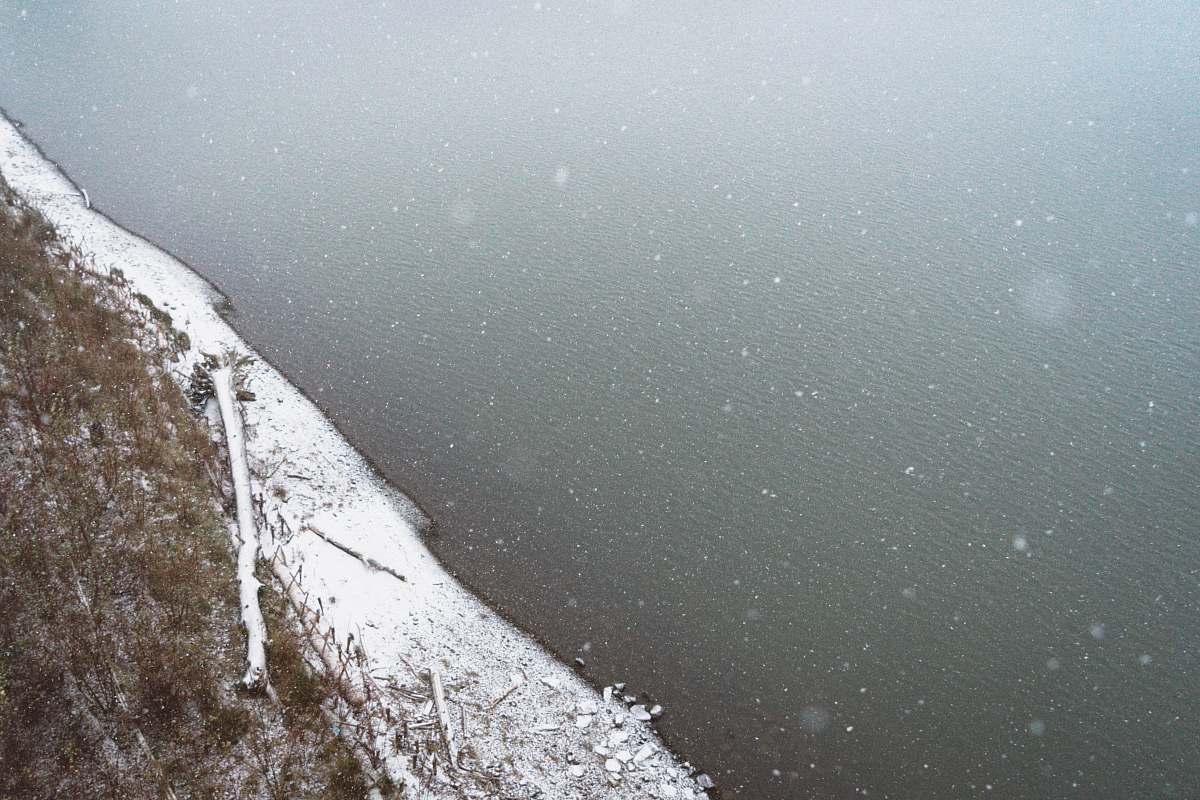 water aerial view photography of ocean beside snow-covered shore shore