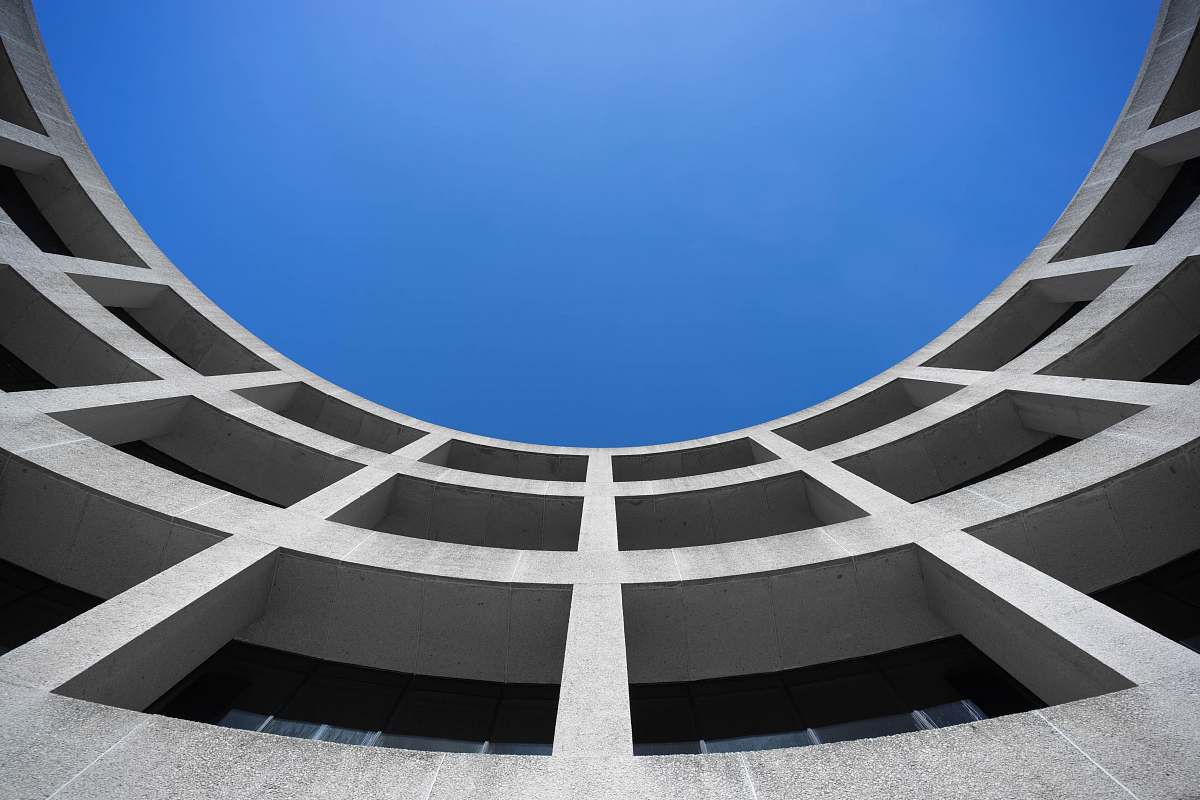 building low angle photography of gray concrete building at day time blue