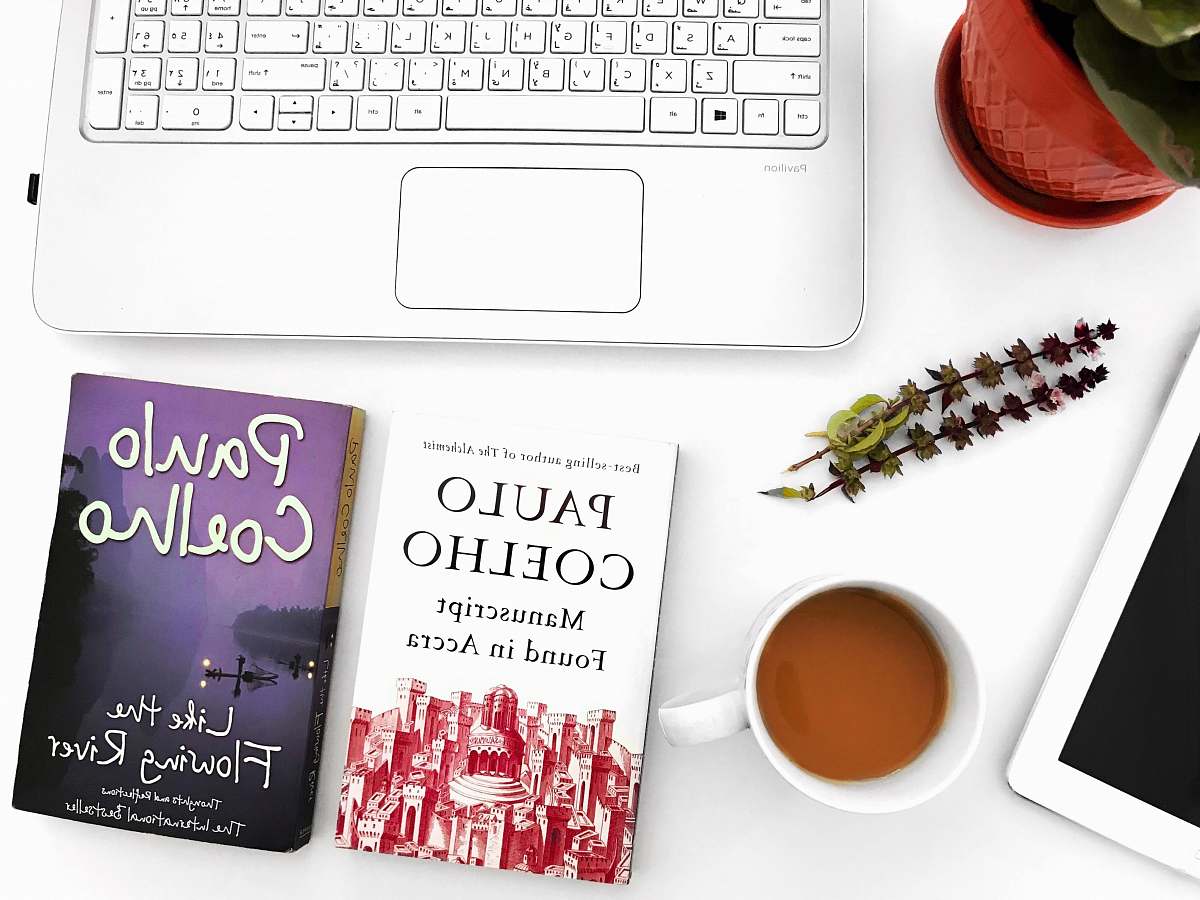 workspace two Paulo Coelho books on table books