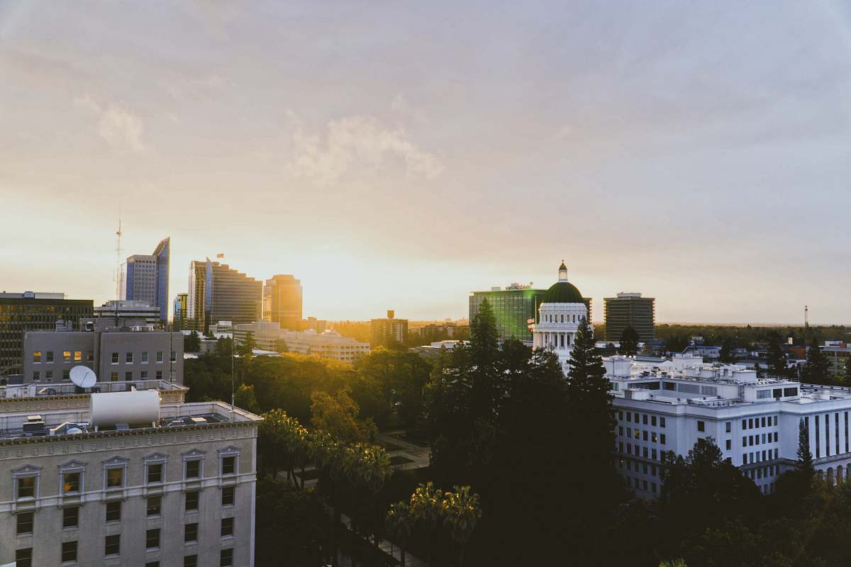 city aerial photography of city with high-rise buildings under white and yellow sky during daytime office building