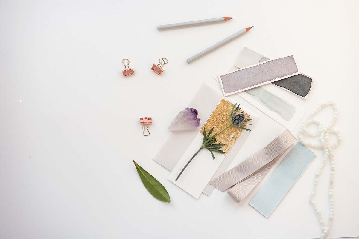 flatlay flowers on card near pencil clips