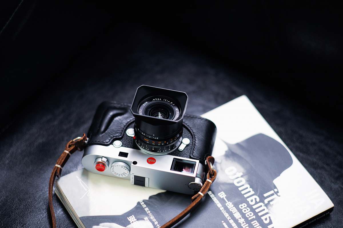 camera black and gray digital camera on book electronics