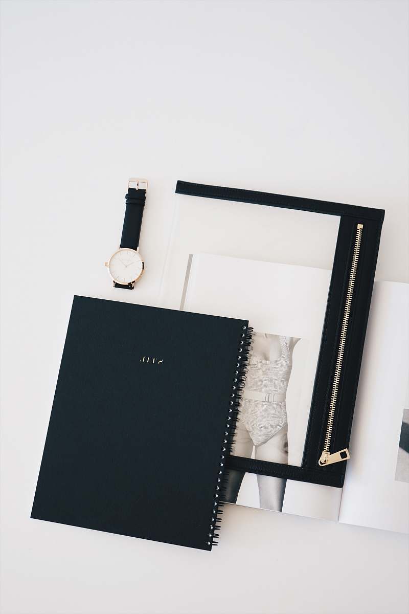 minimalism flat lay photo of watch, notebook, and watch blackboard
