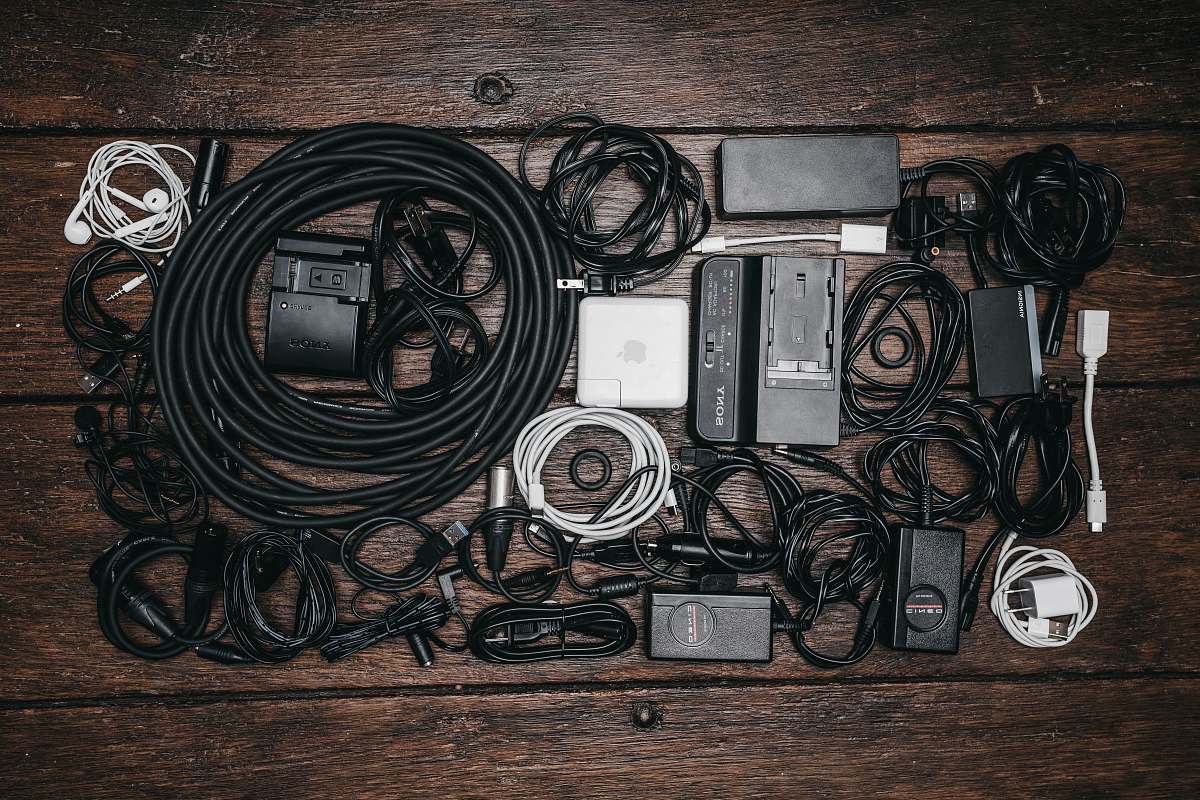 saskatoon black cable lot and electronic devices on brown wooden surface canada