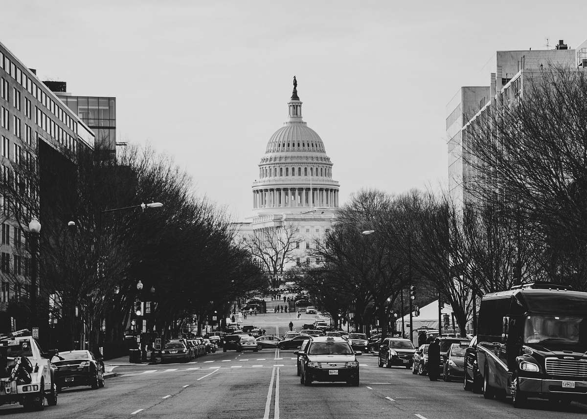 black-and-white cars and bus parked at roadside near Capitol Hill road