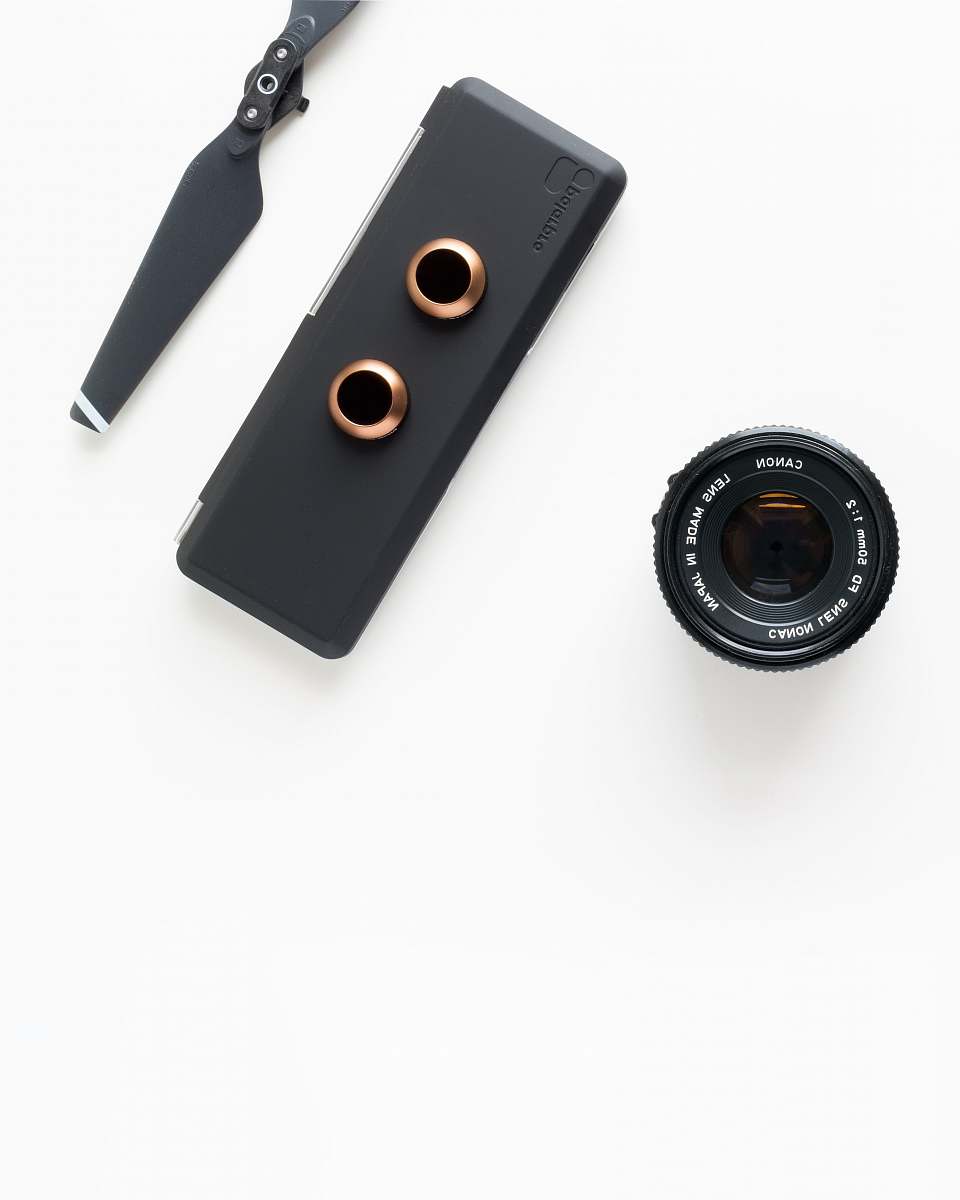 modern closeup photo of black camera attachments on white surface minimal