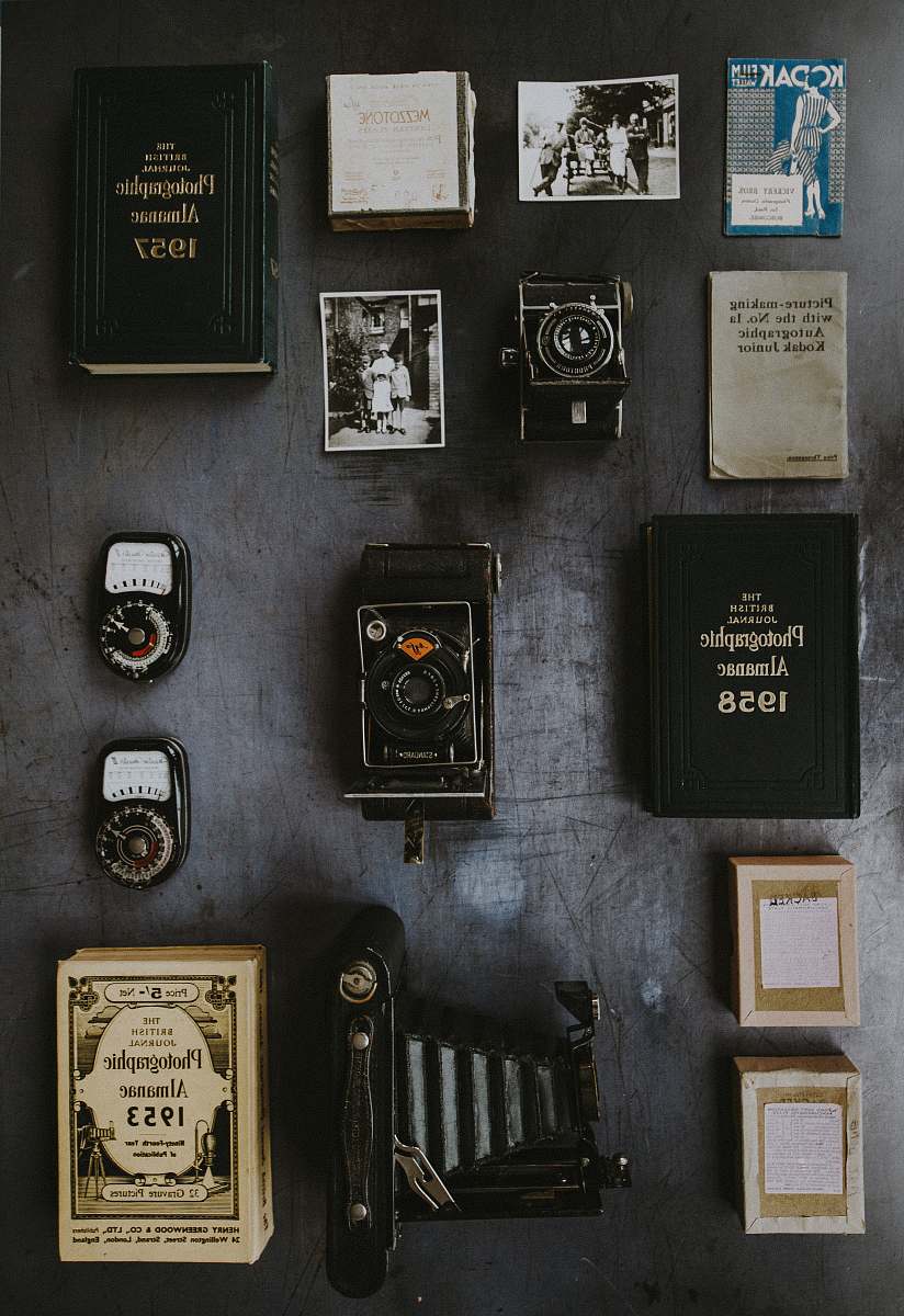 camera flat lay photography of classic cameras and films gear