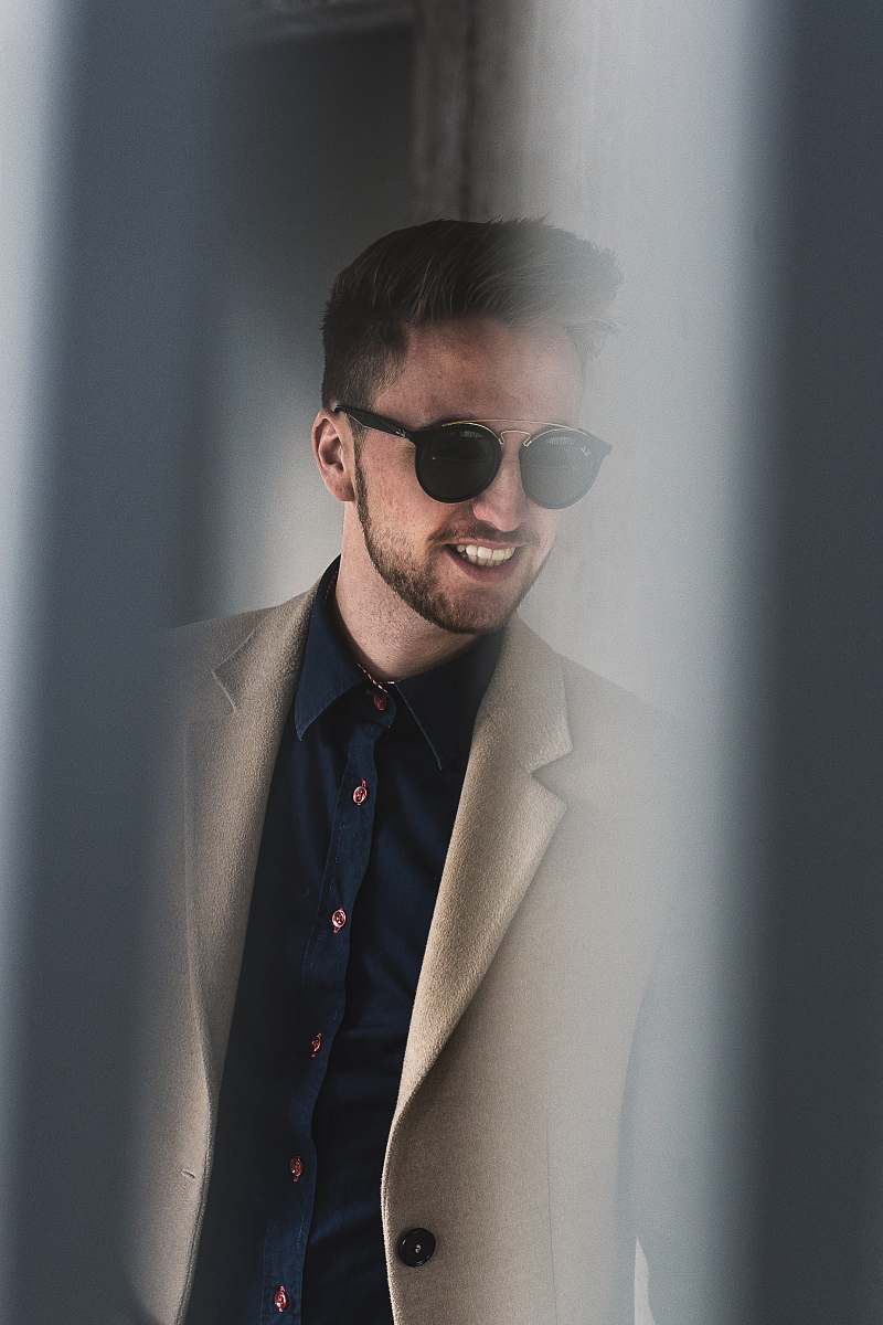 human man standing beside wall person