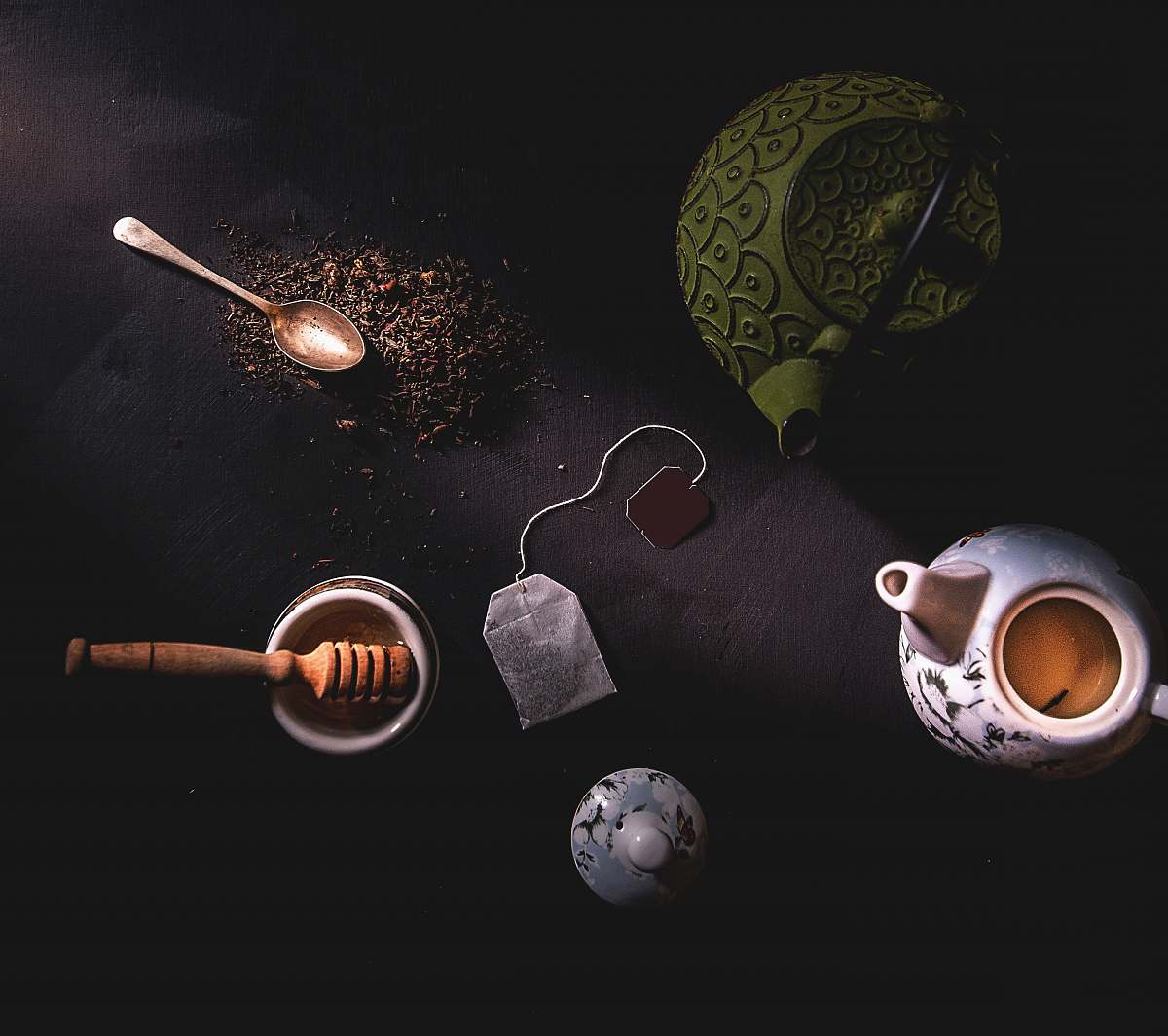 food two teapots beside mortar and pestle cup