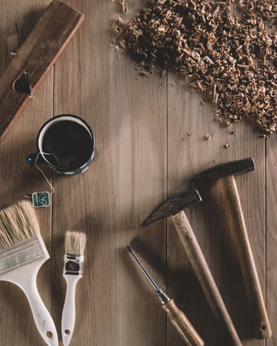 brown two hammers beside screwdriver worktop