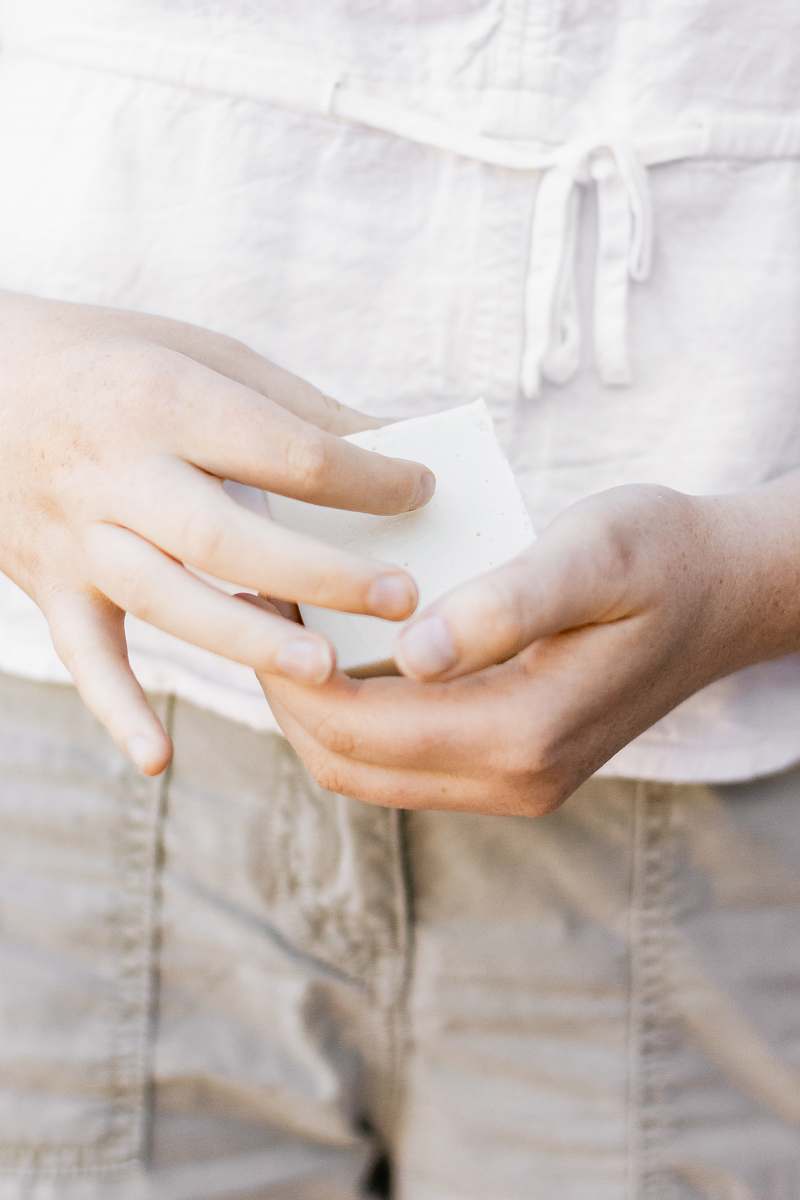  person holding white square ornament 