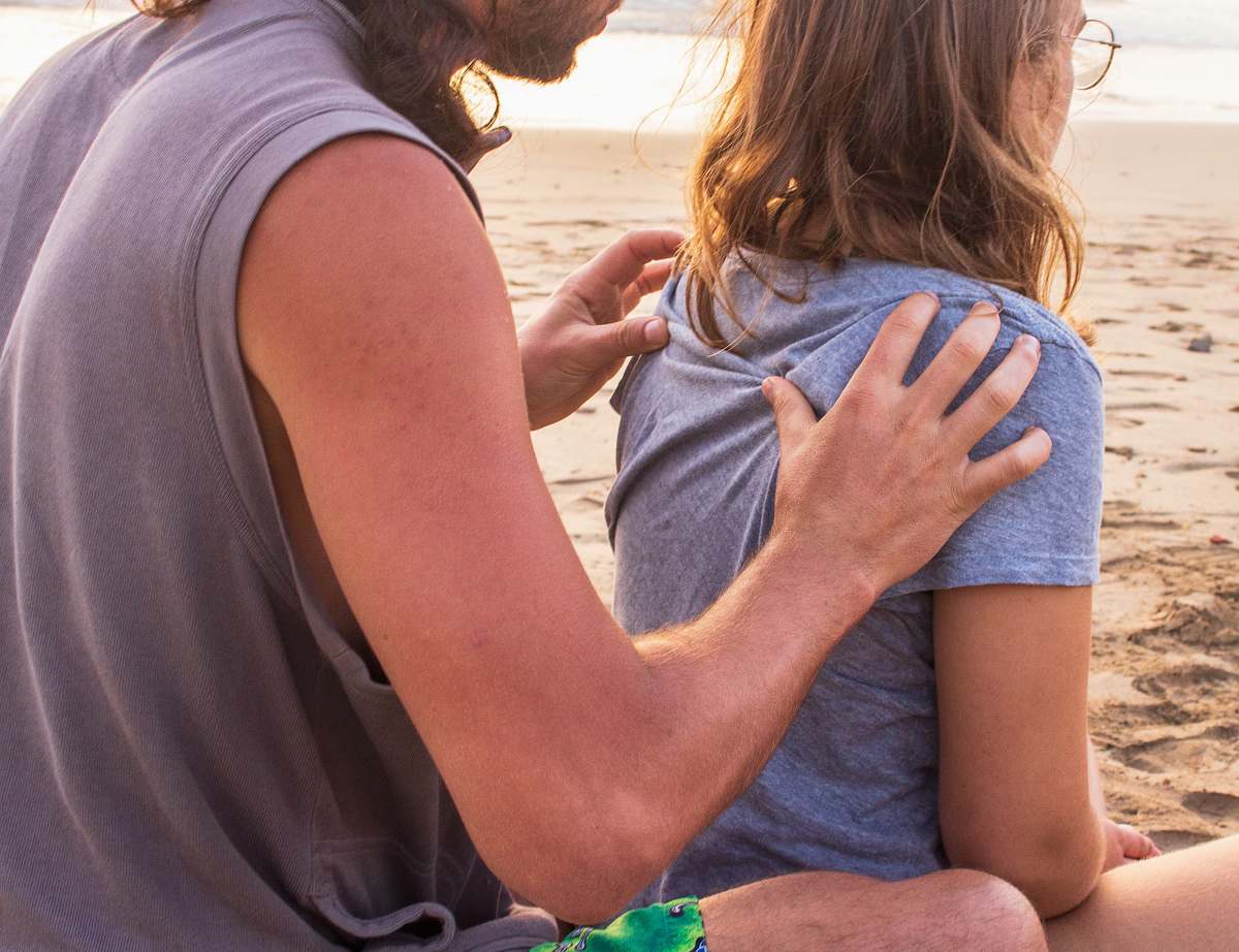 human man massaging woman at the back person