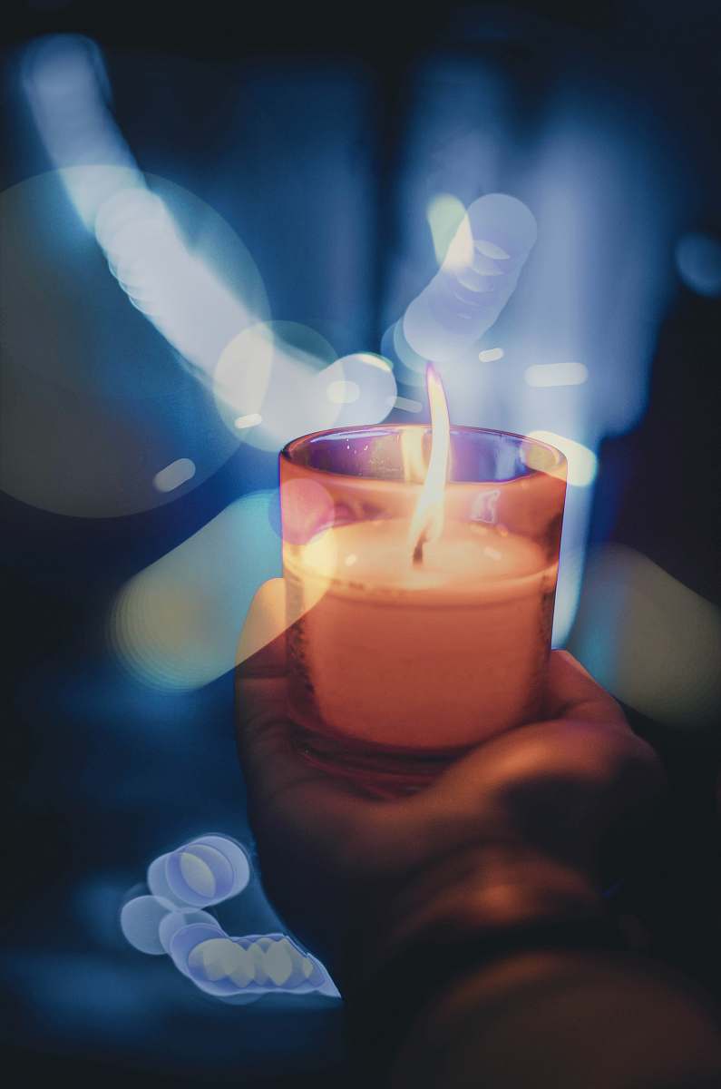 flame person holding lighted votive candle fire