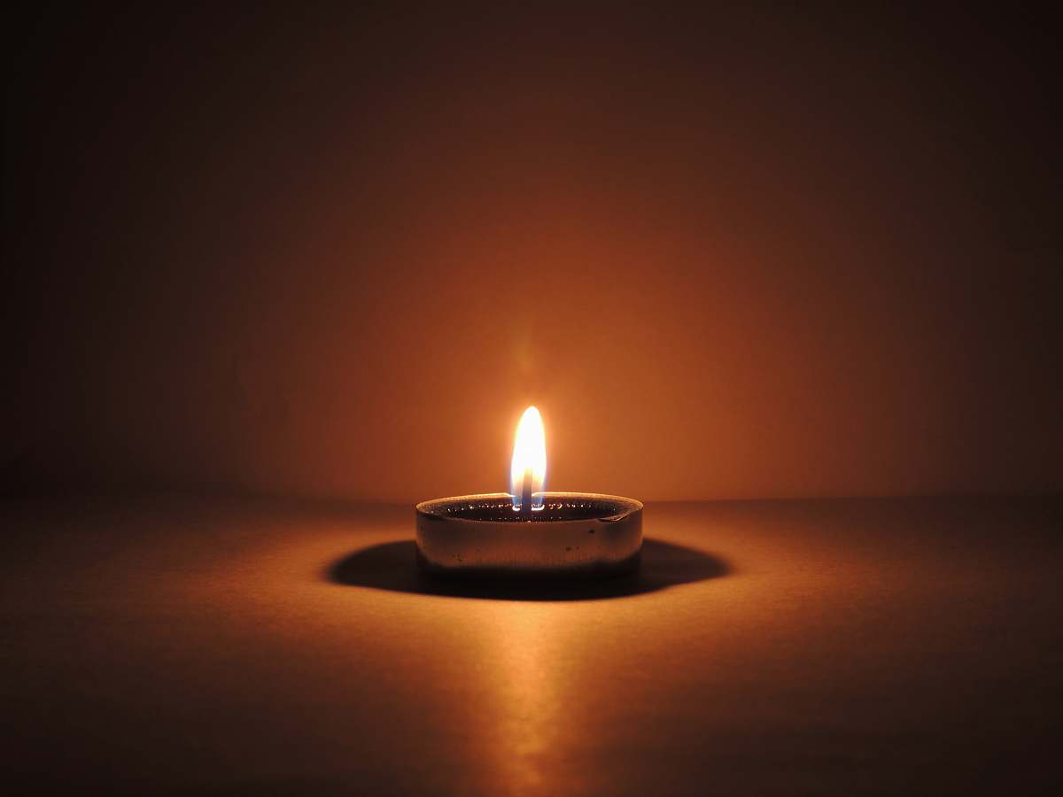 fire round ceramic bowl with lighted candle brown