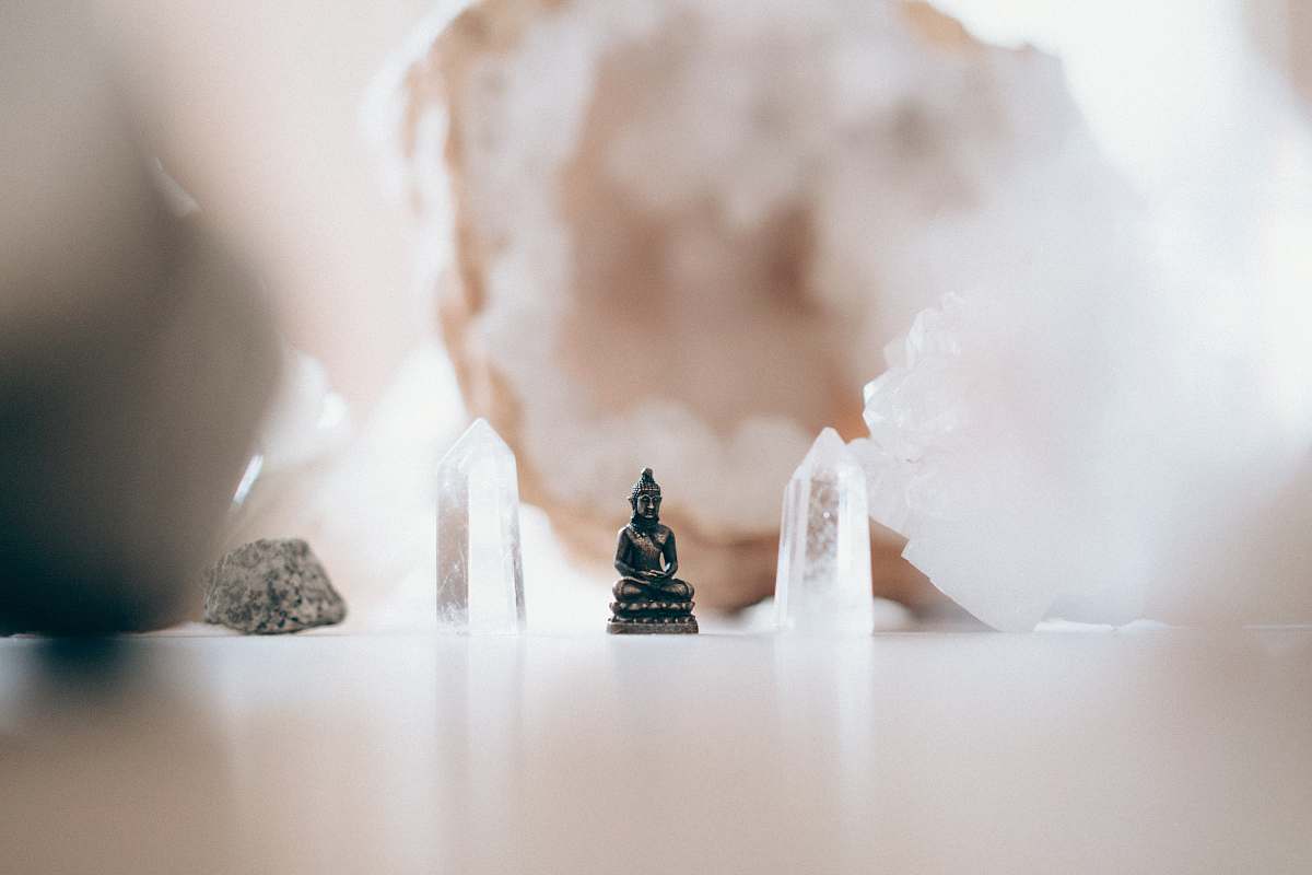 yoga macro photography of black ceramic Gautama Buddha miniature buddah