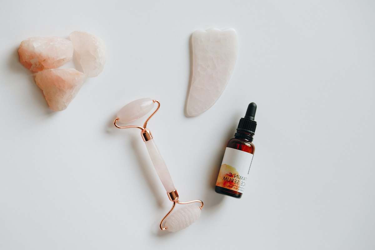 bottle white and black plastic bottle beside white heart shaped ornament guasha