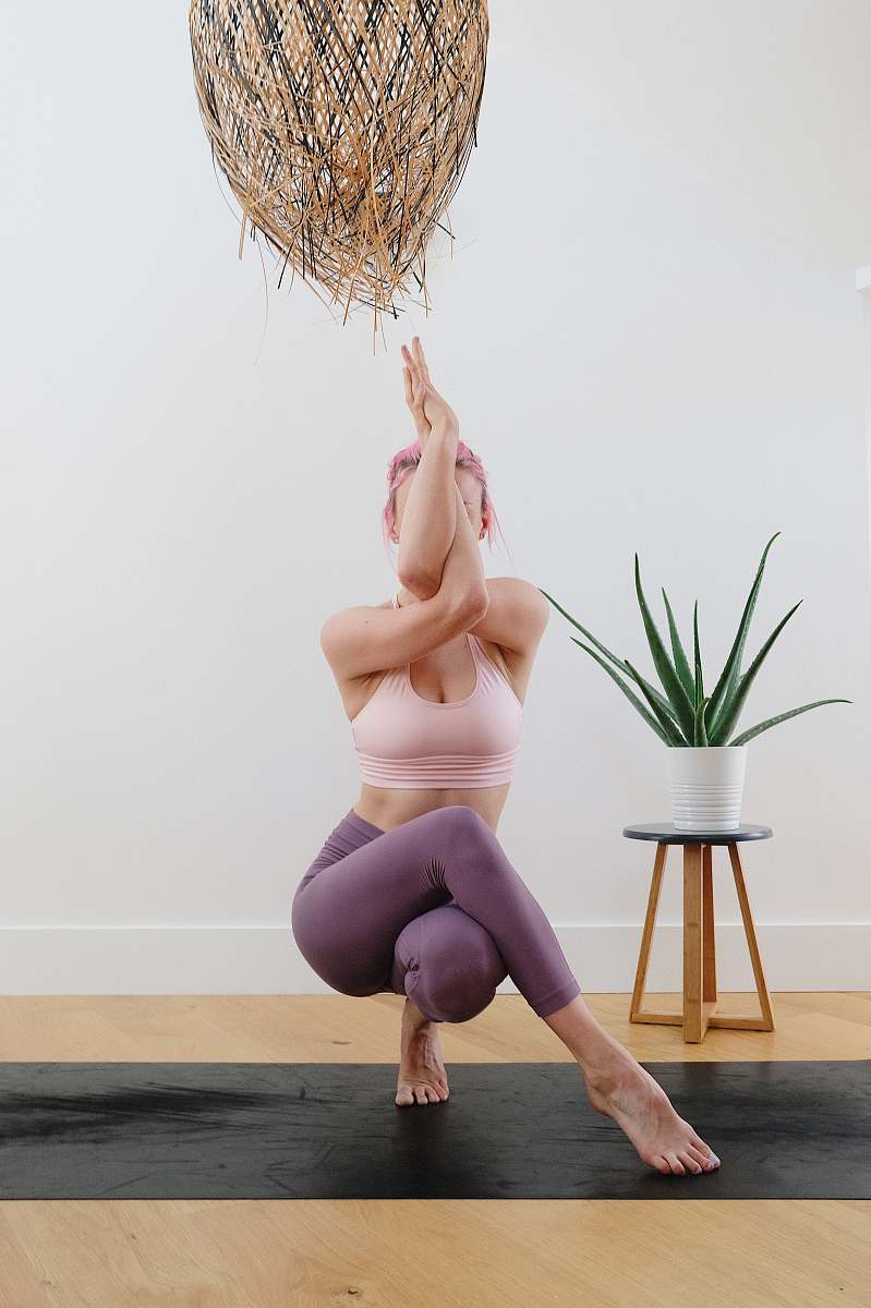 person woman in black panty kneeling on floor yoga mat
