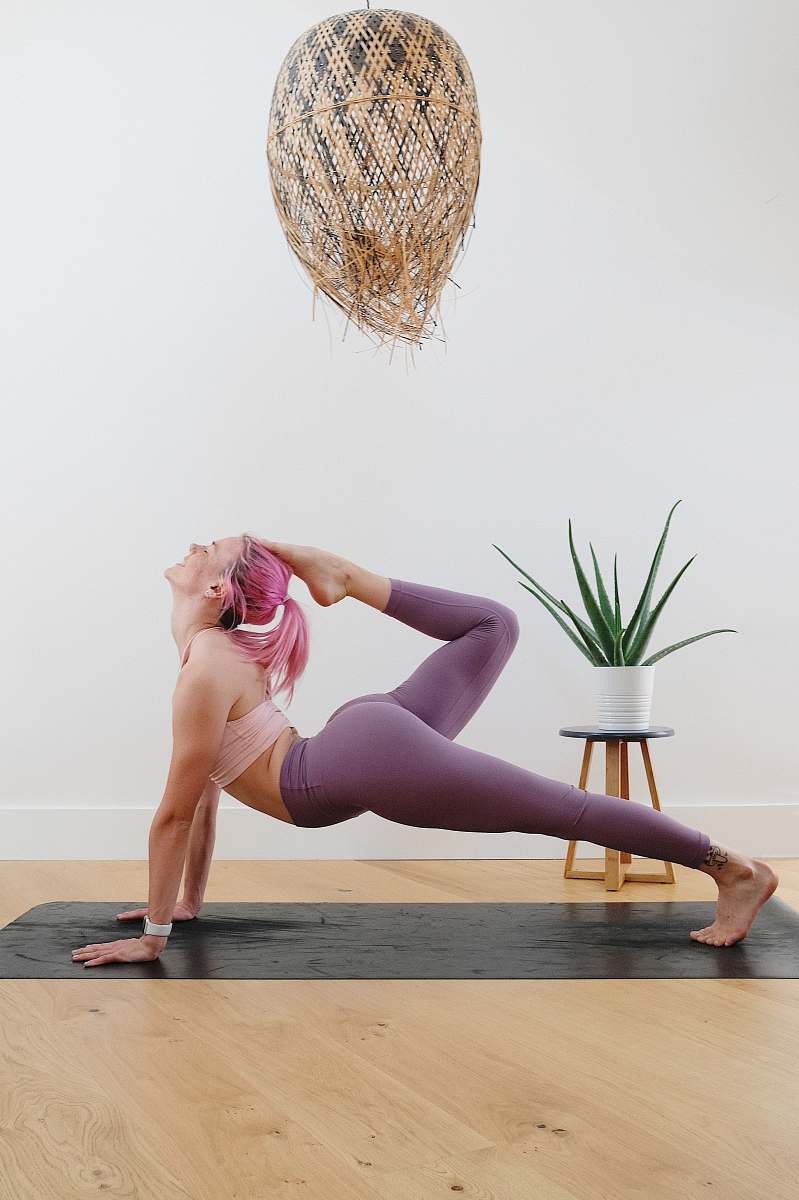 fitness woman in pink one piece swimsuit kneeling on floor exercise