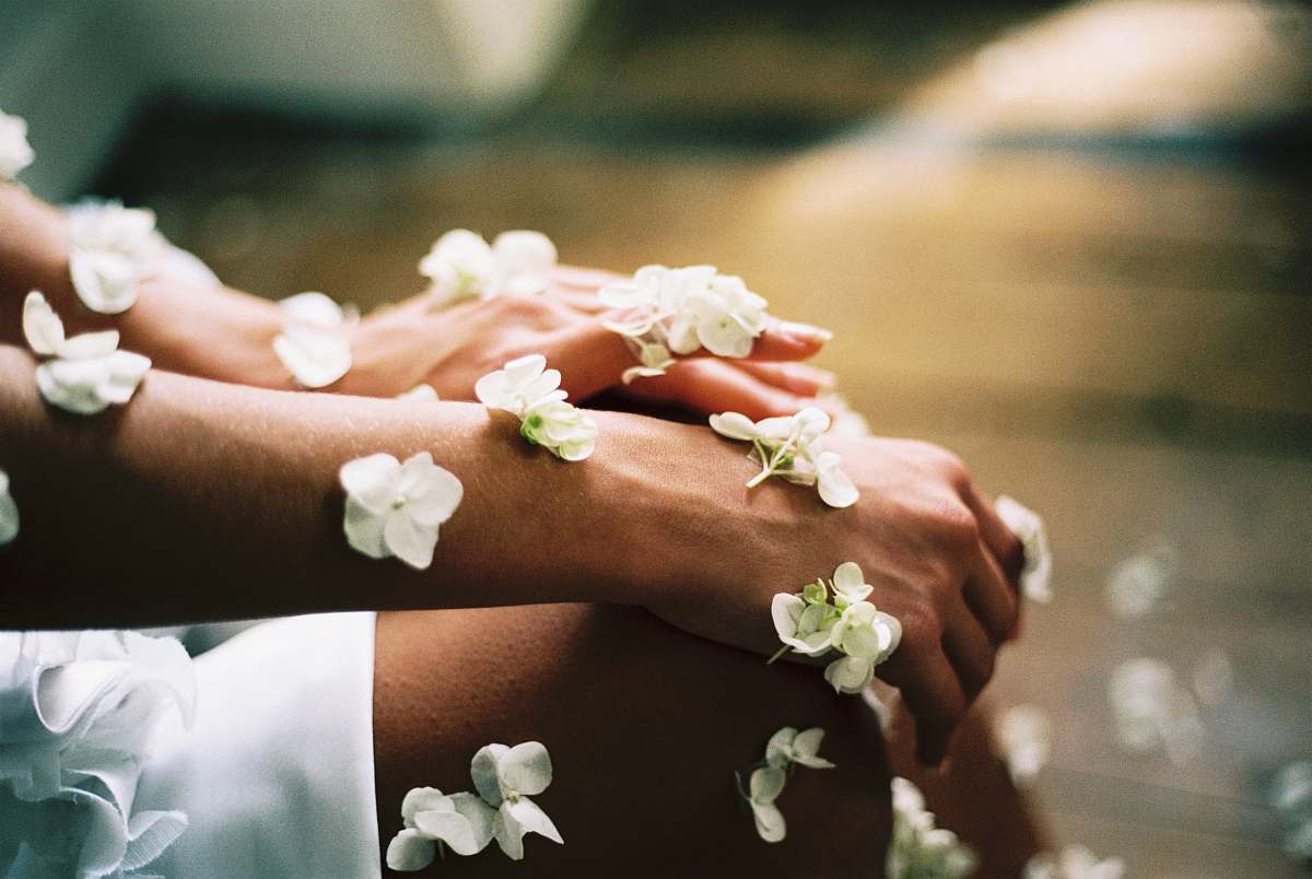 spa person surrounded by white flowers blossom