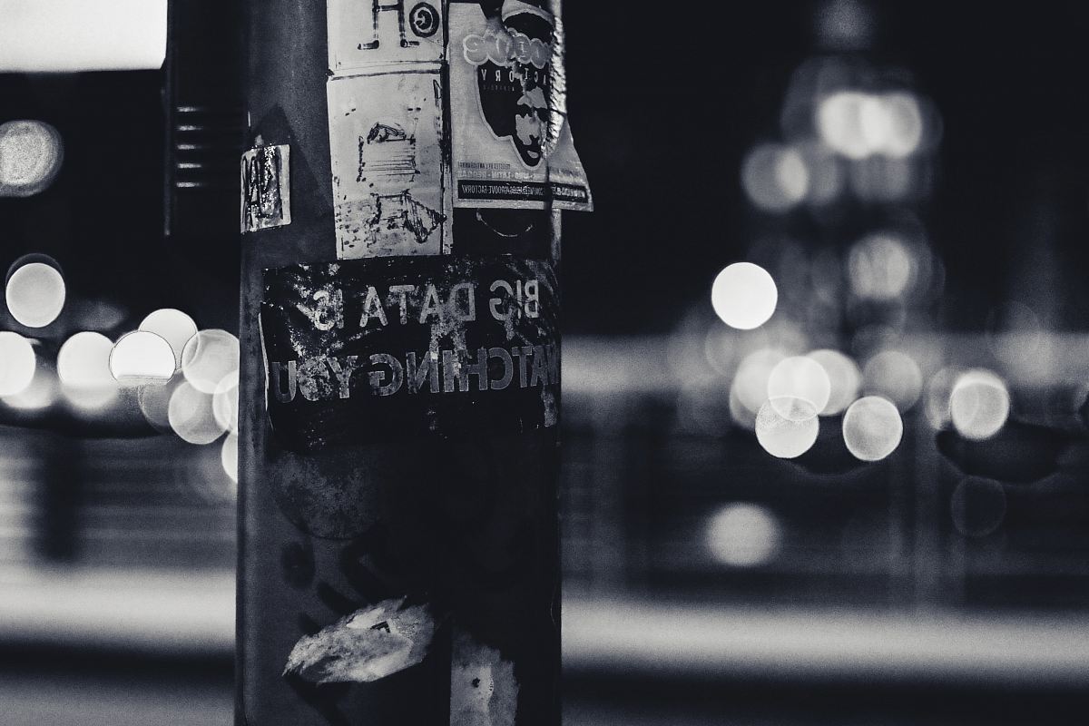 a pole with a bunch of stickers on it