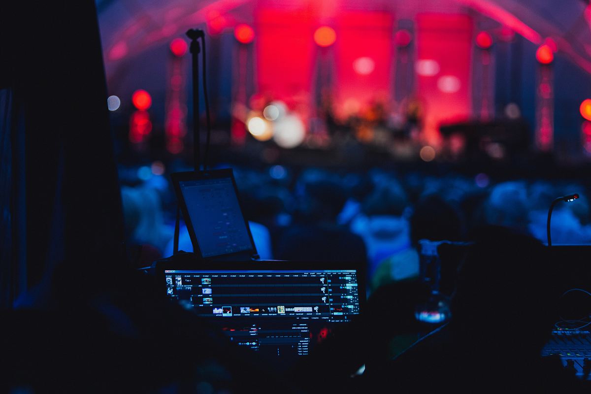 a stage with a dj and a dj in the fore