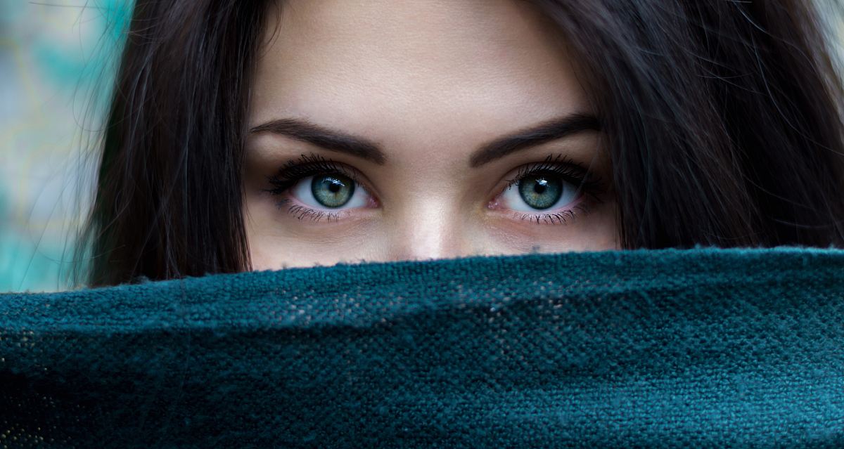 a woman with long hair and green eyes