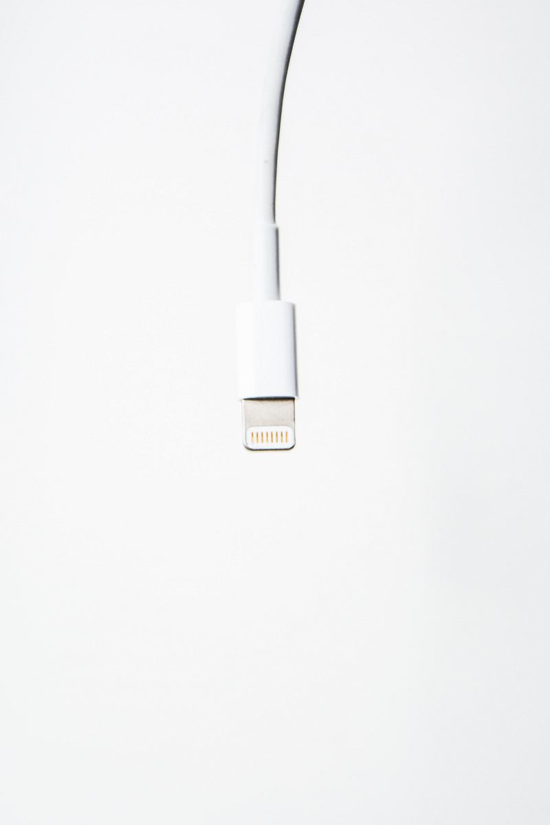 A white USB cord dangling from above.