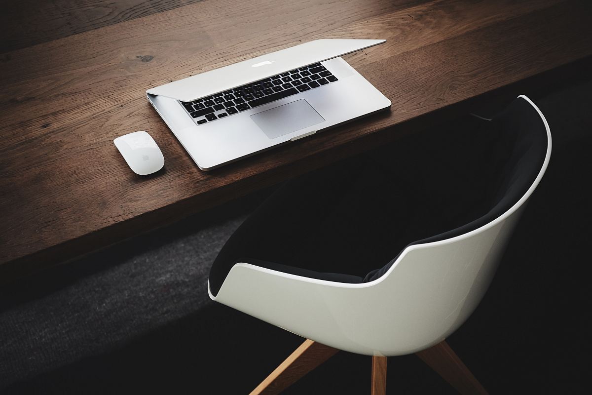 Apple MacBook beside computer mouse on table