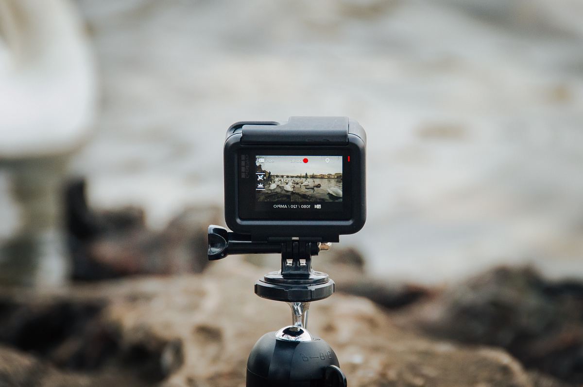 black action camera on tripod