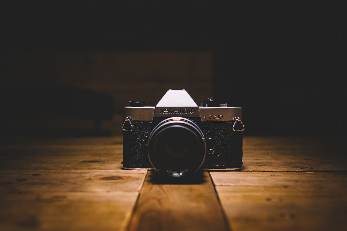 black and gray SLR camera on floor
