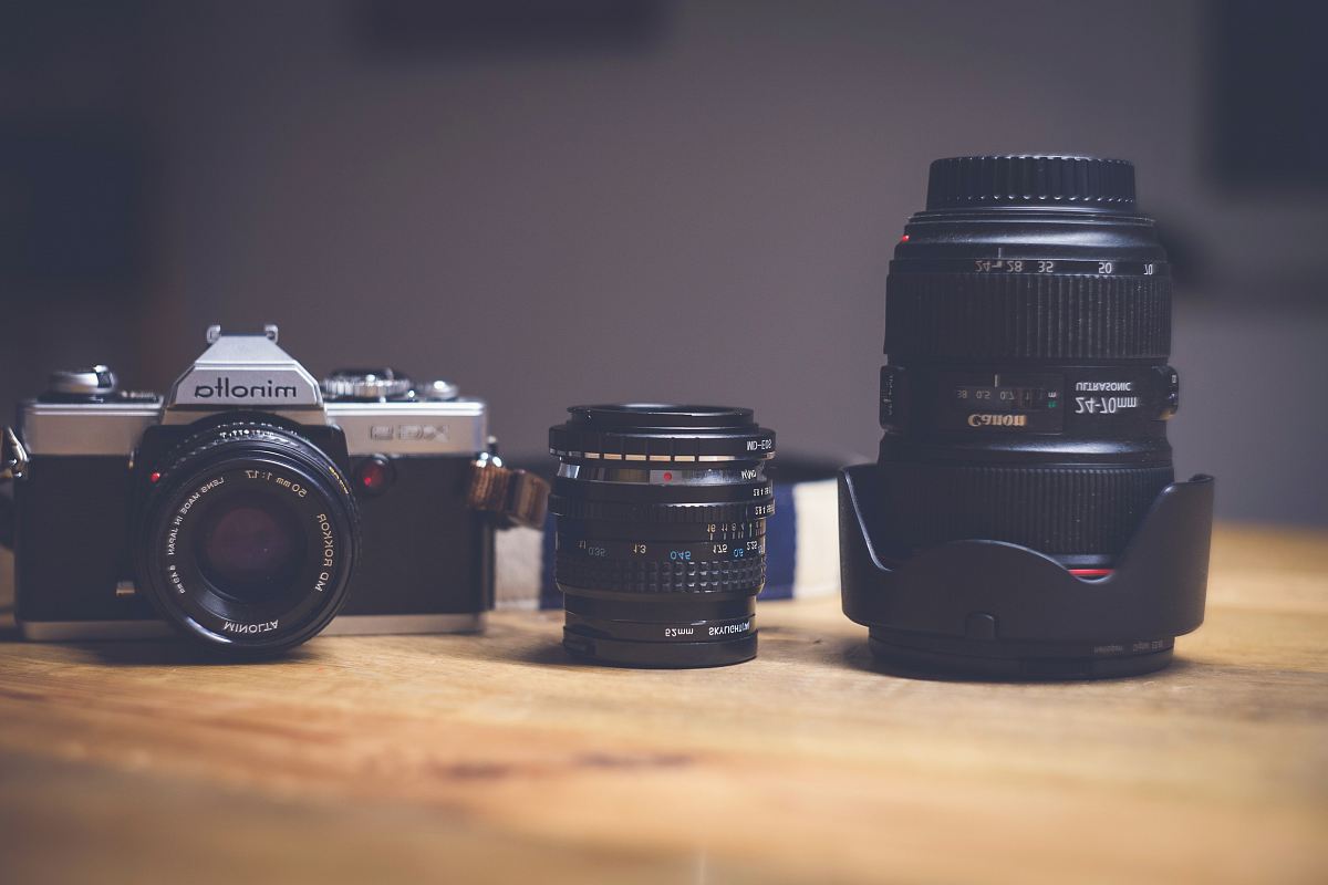 black and silver Minolta camera with zoom lens