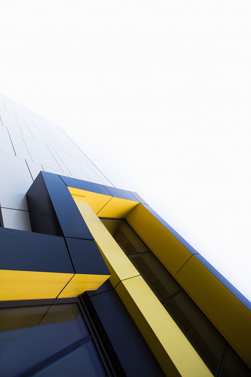 black and yellow building under white clouds