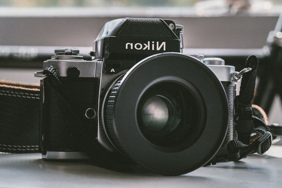 black Nikon milc camera on white panel