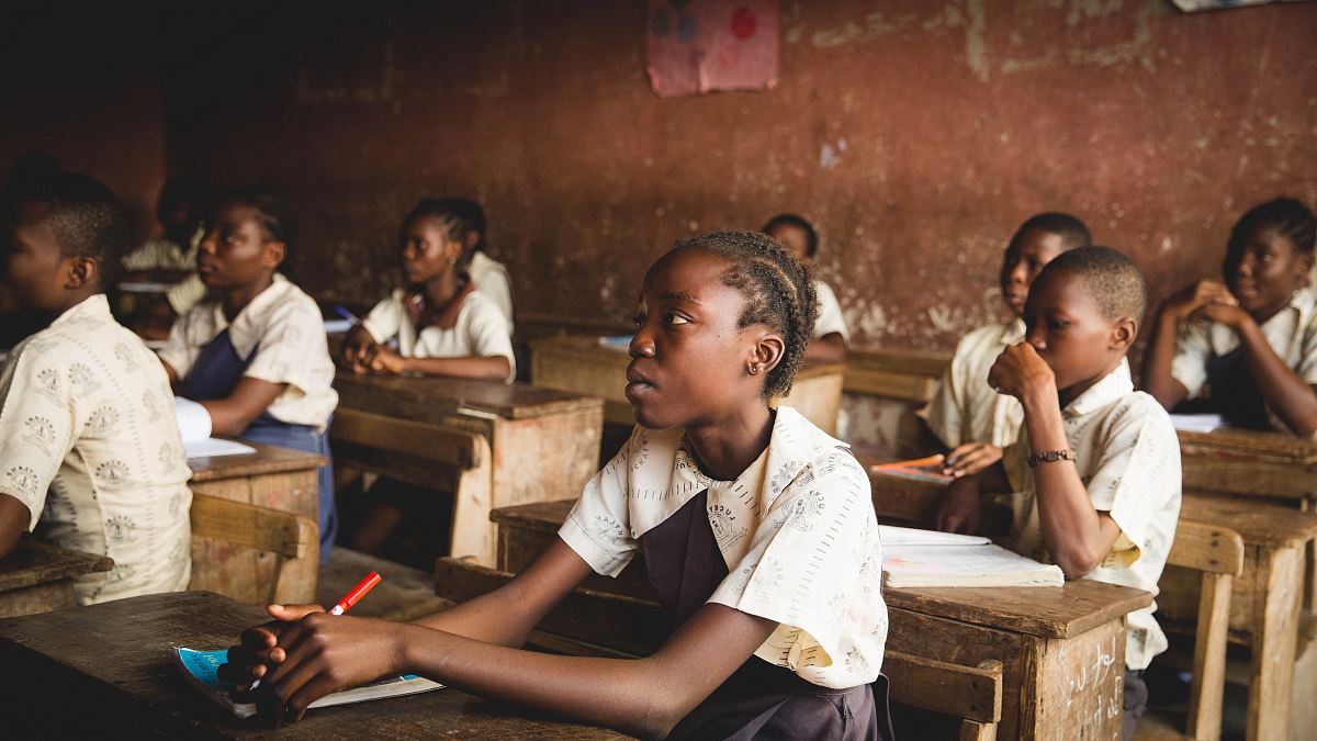 children sitting on chairs inside classroom
