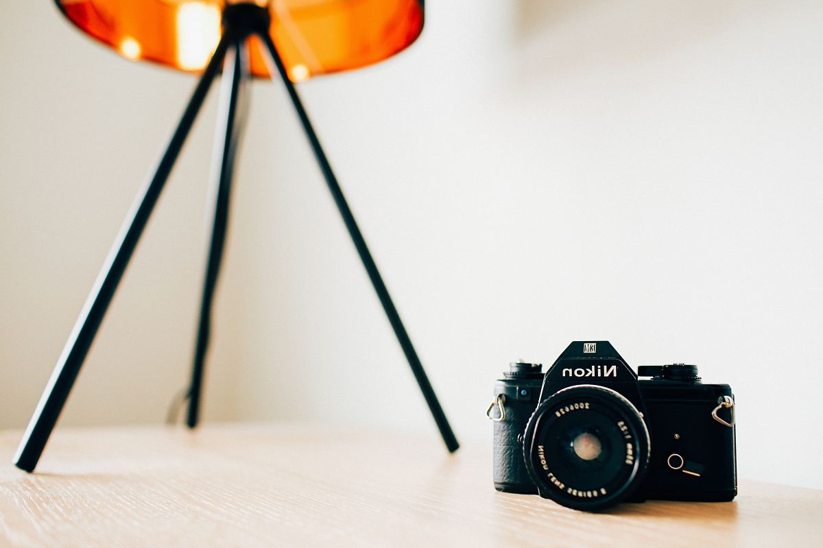 closeup photo of Nikon camera on wooden surface