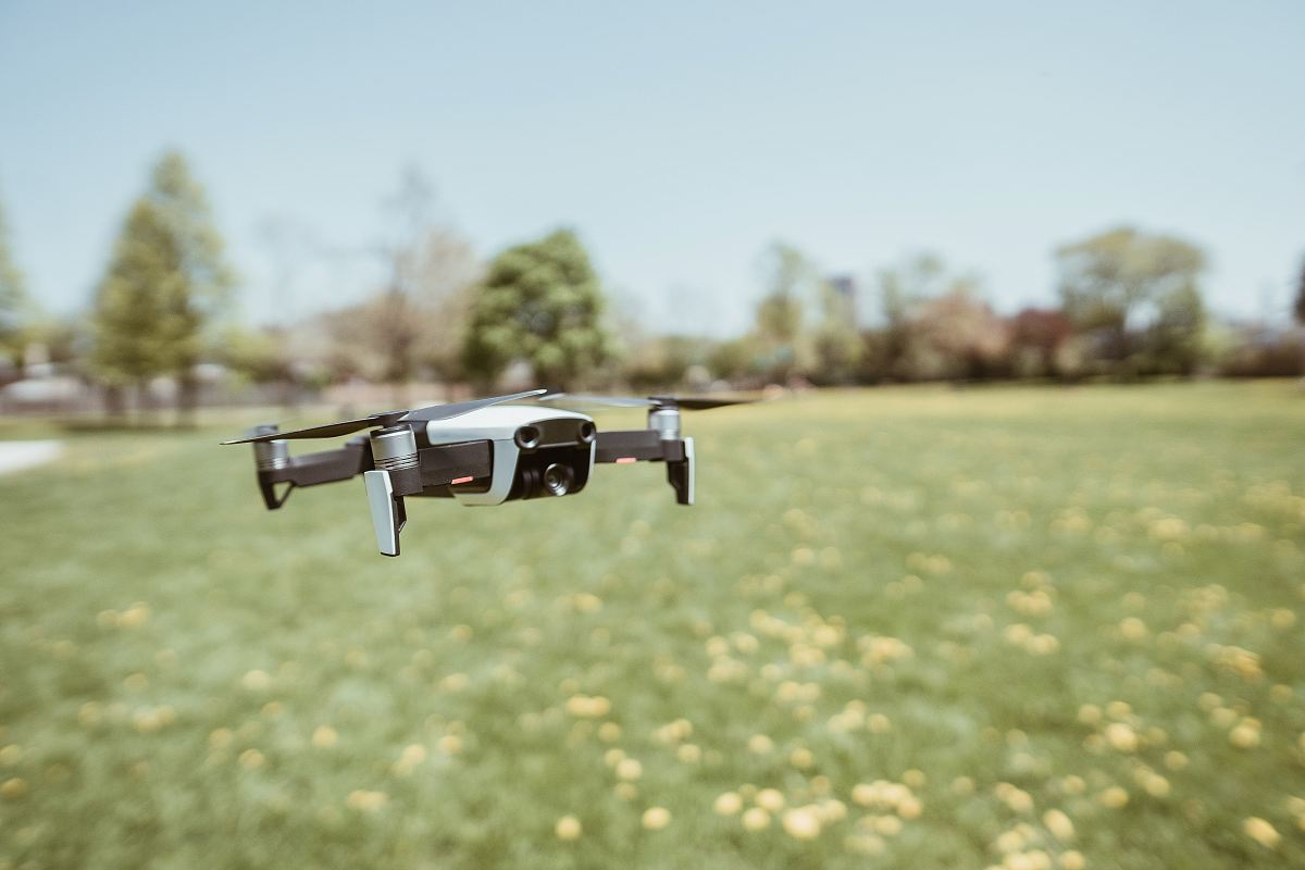 flying white and black drone