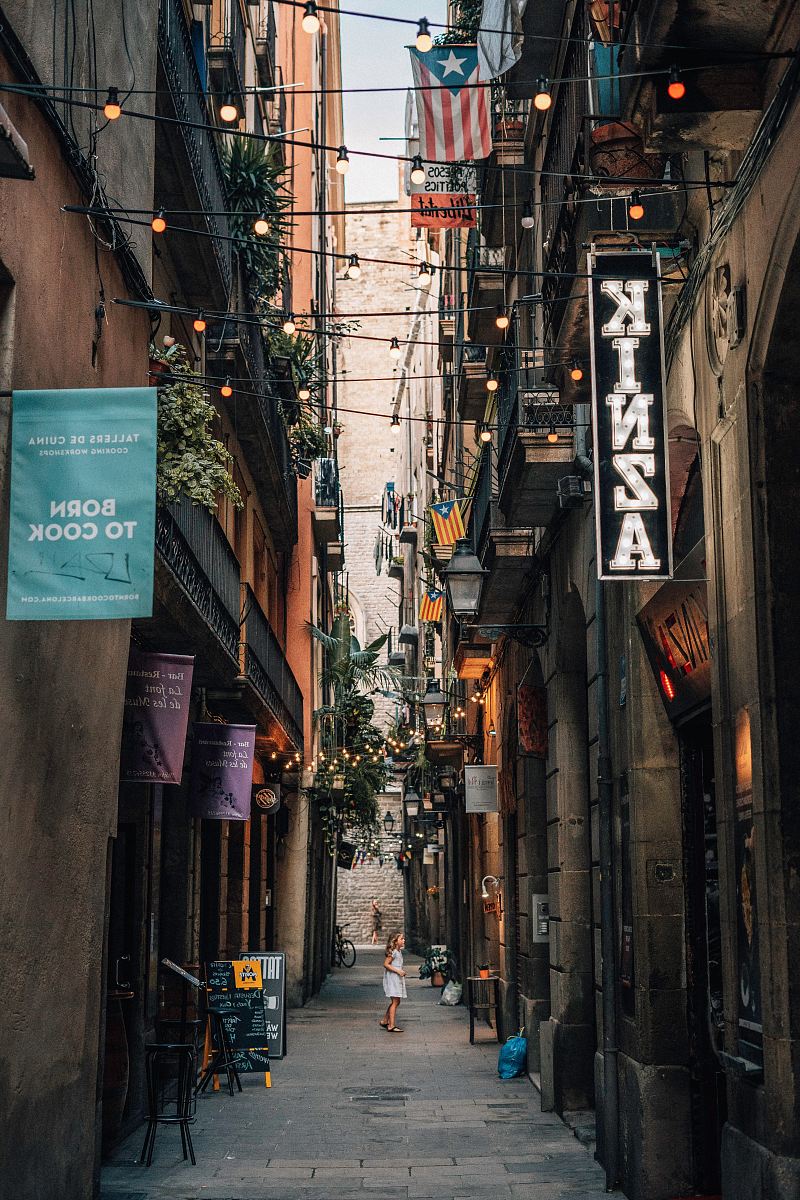 girl stands between alley