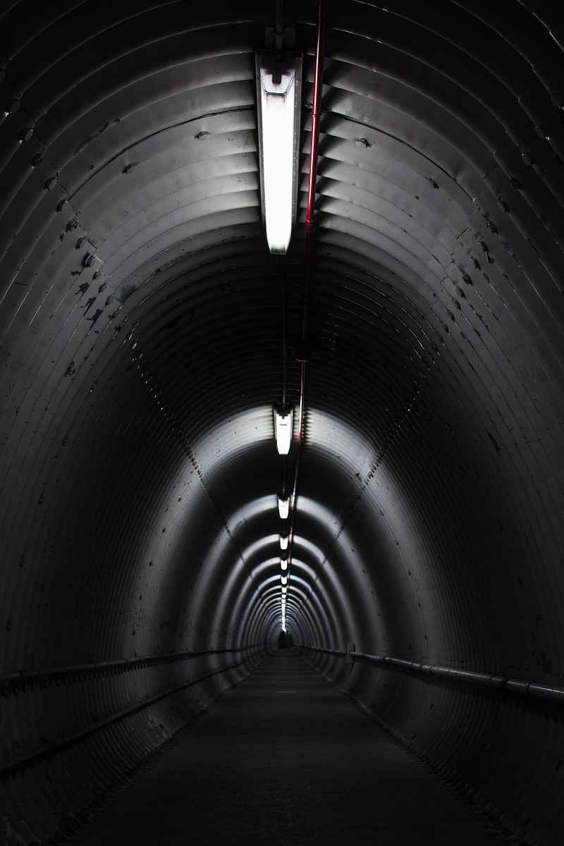gray concrete tunnel with light