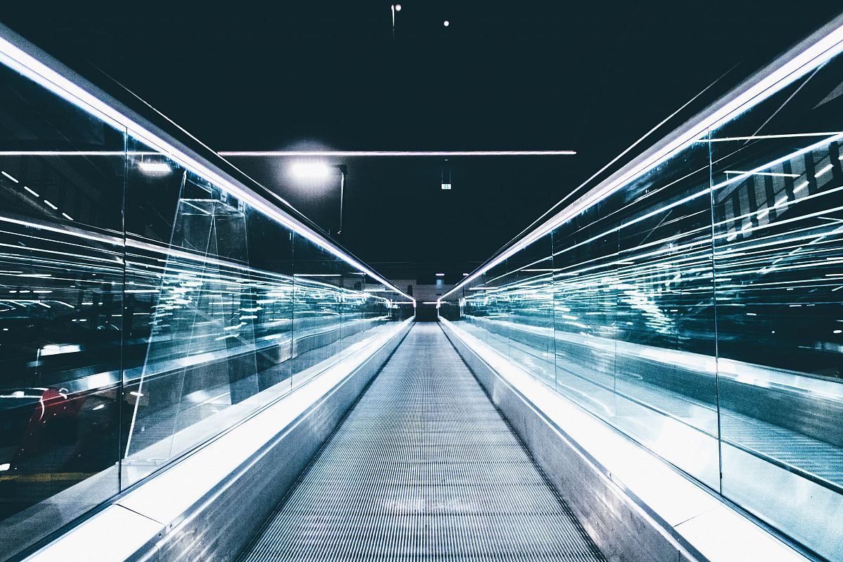 gray conveyor between glass frames at nighttime