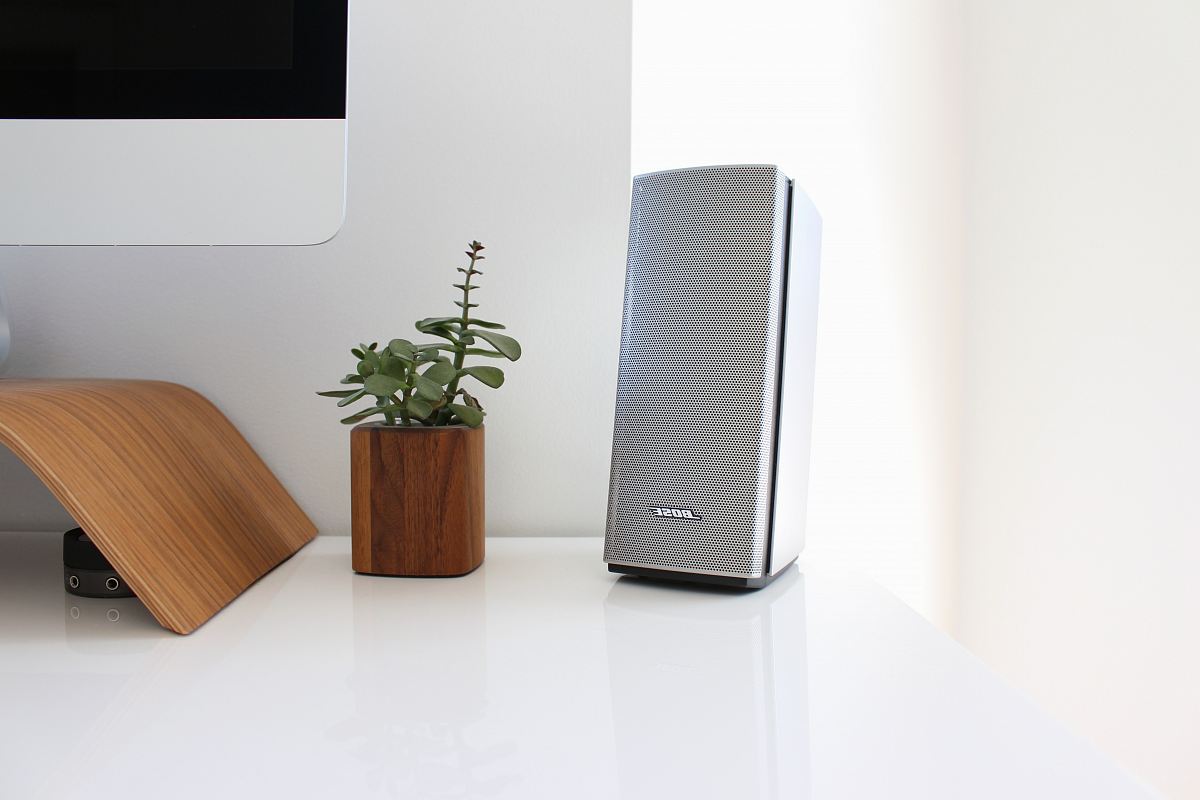 gray speaker on table near brown wooden pto