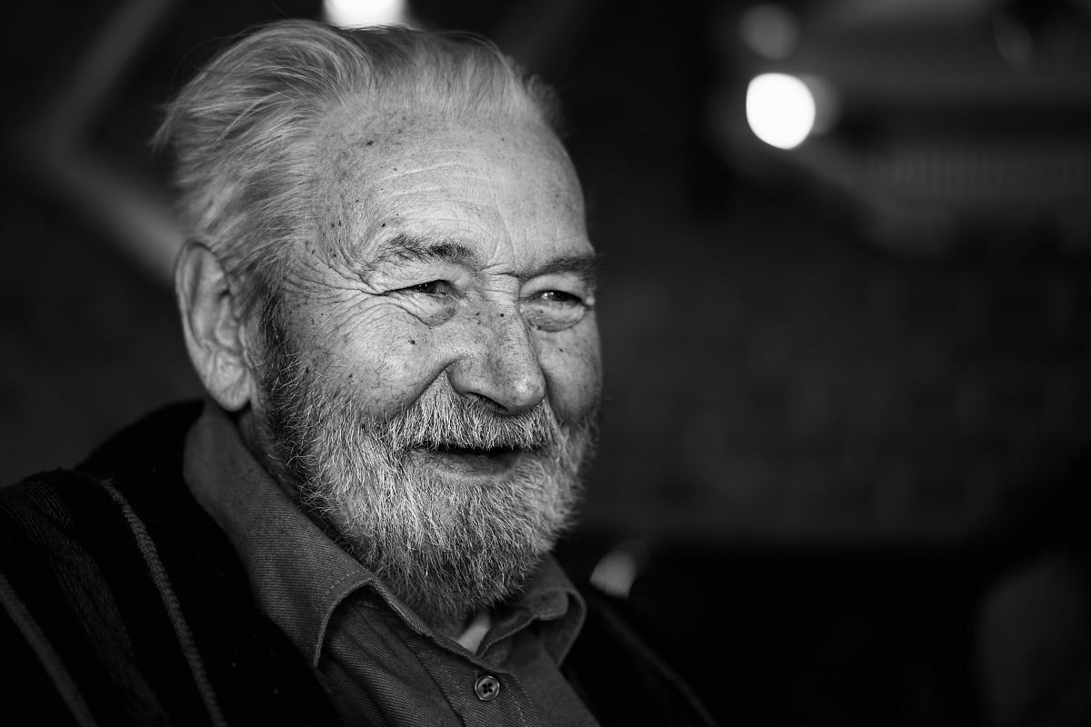 grayscale photography of man wearing button-up collared shirt