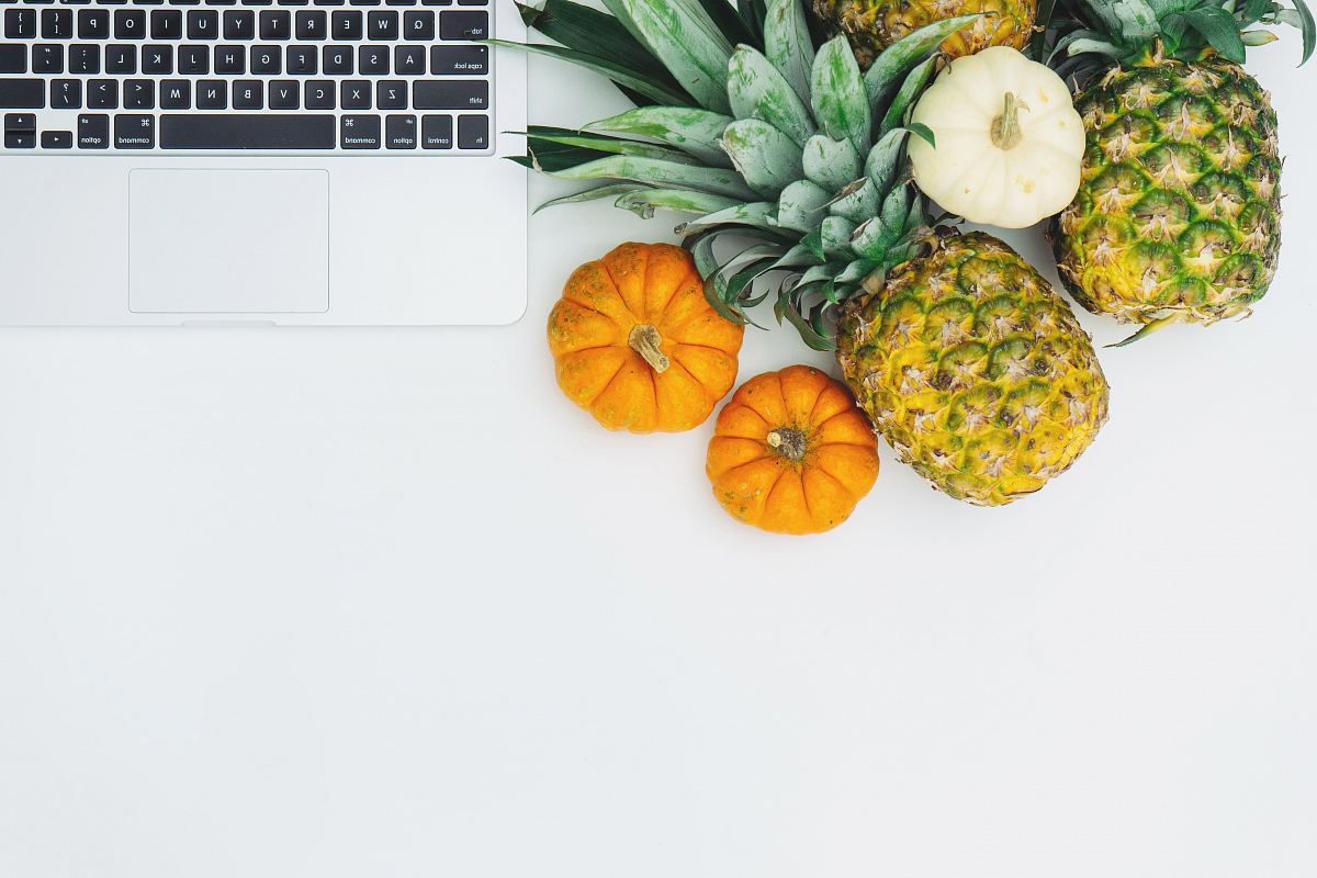 green pineapple fruit near MacBook