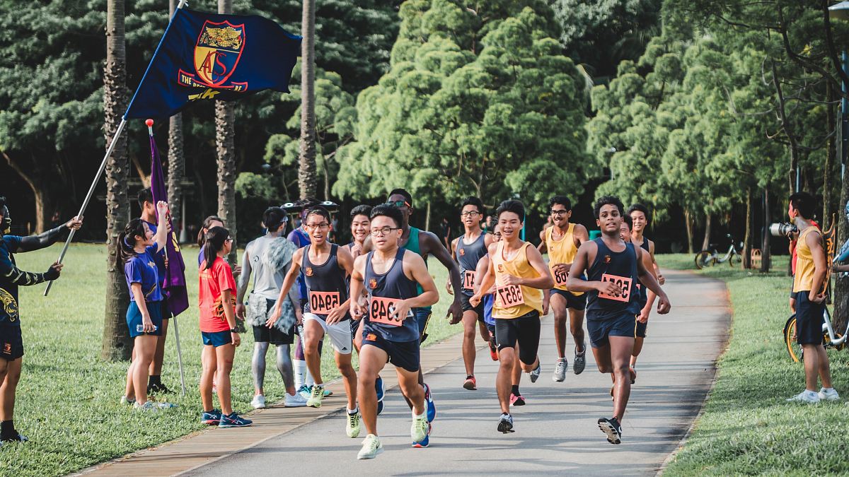 group of men running on pathway