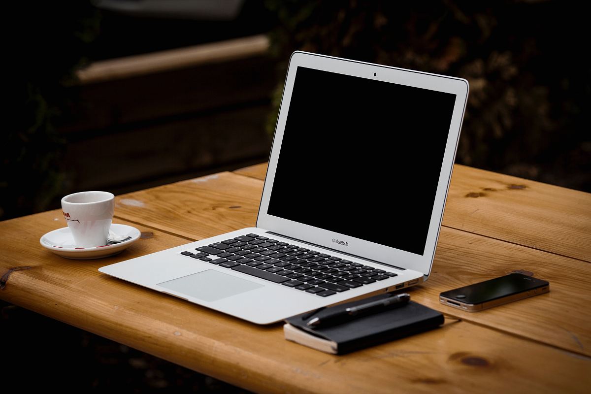 MacBook Air near mug on table