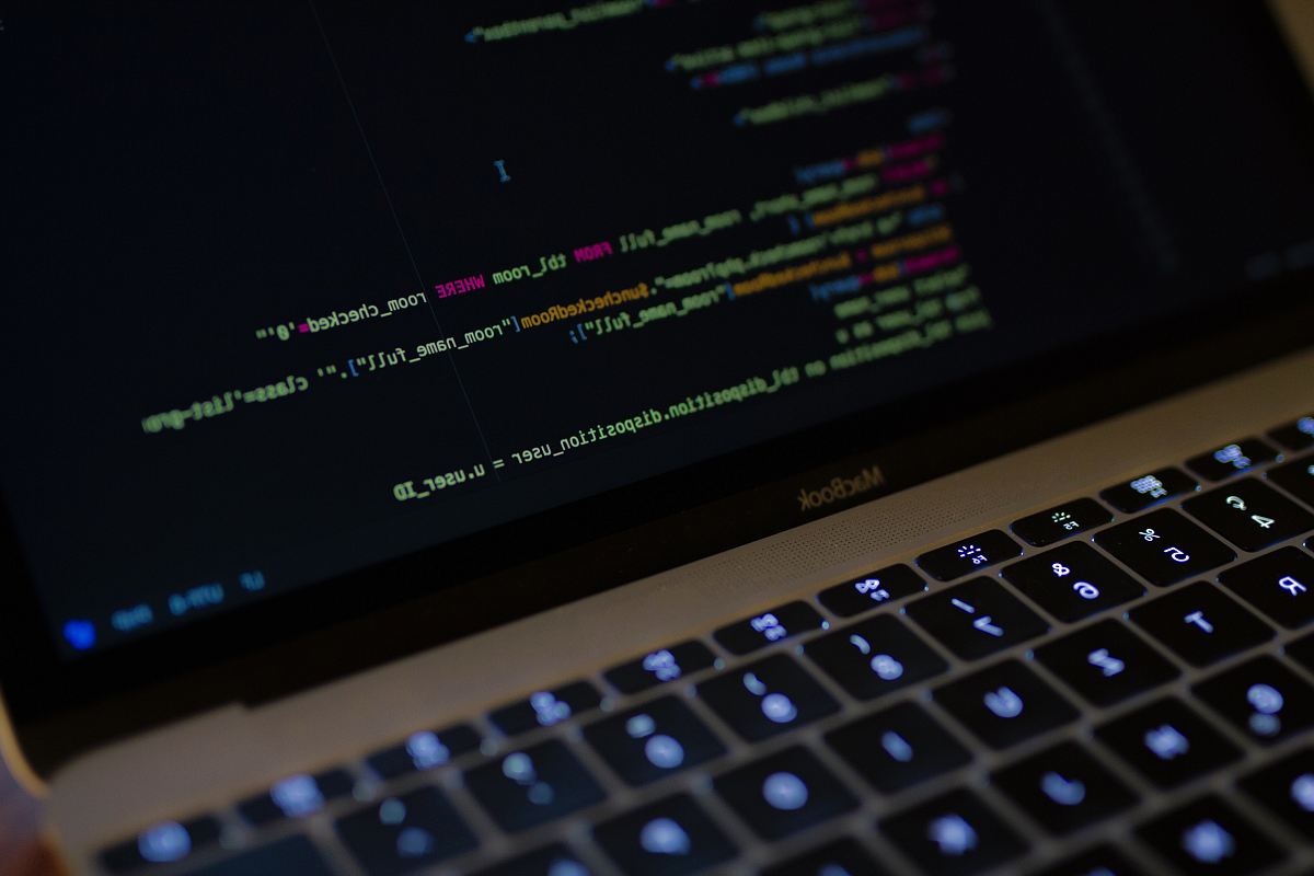 MacBook Pro with images of computer language codes