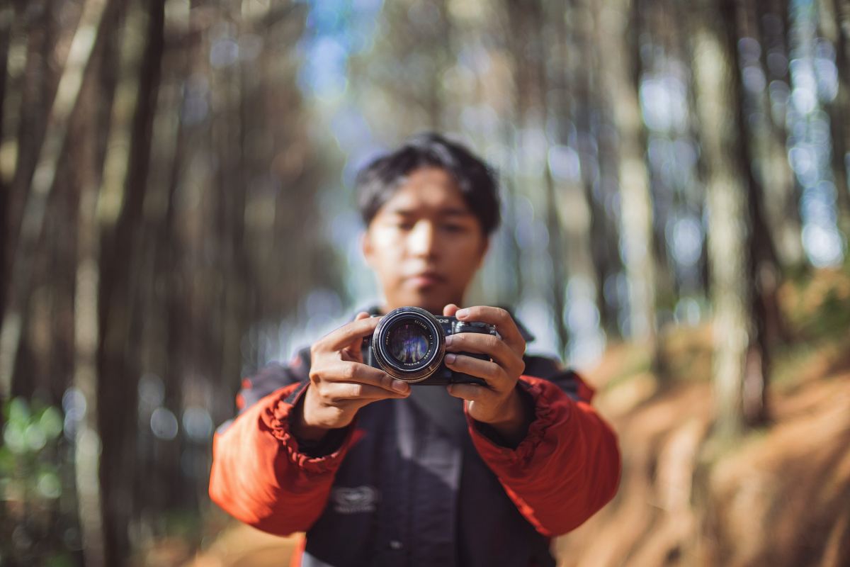 man holding camera taking a photo