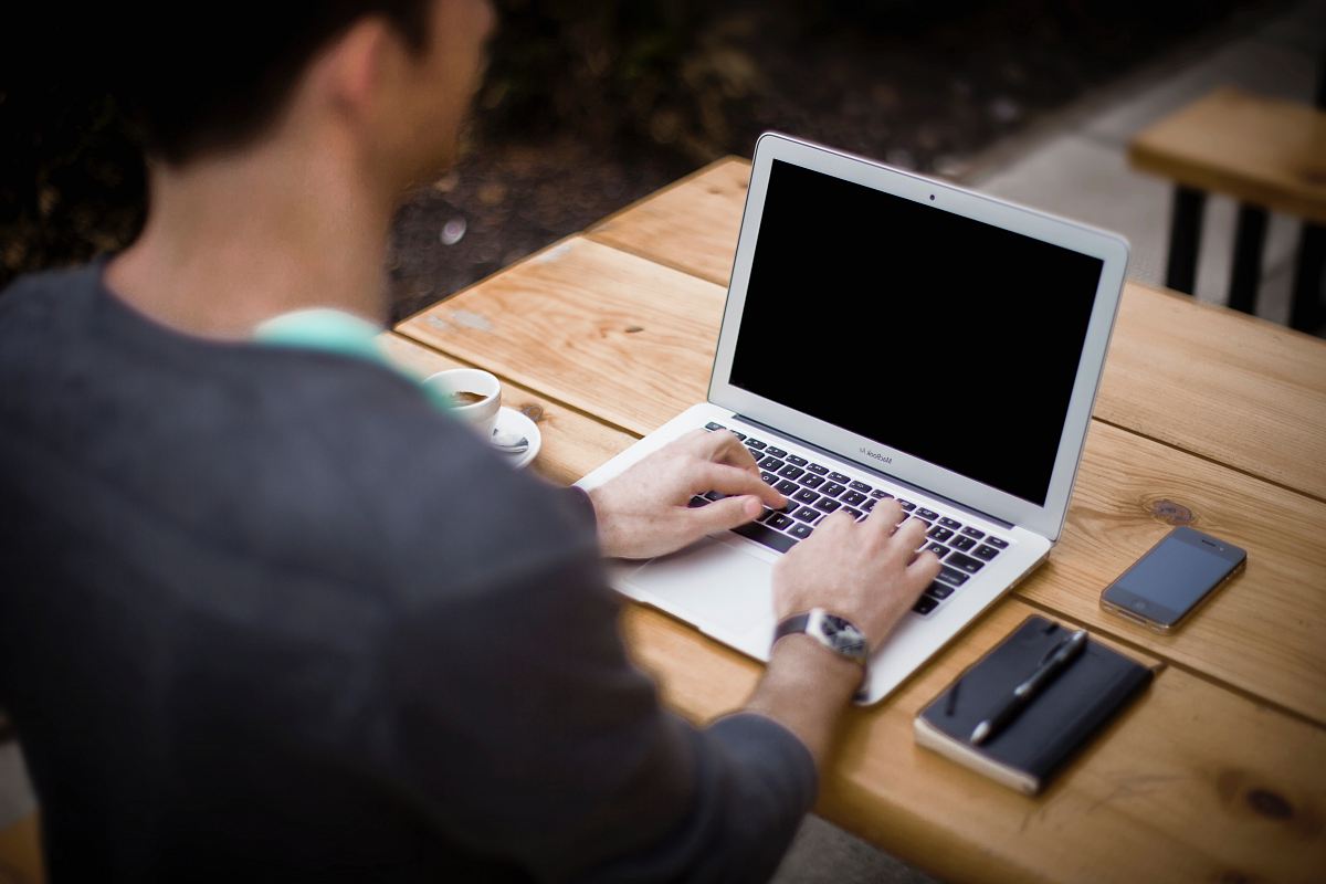 man in front of laptop computer in shallow focus photography